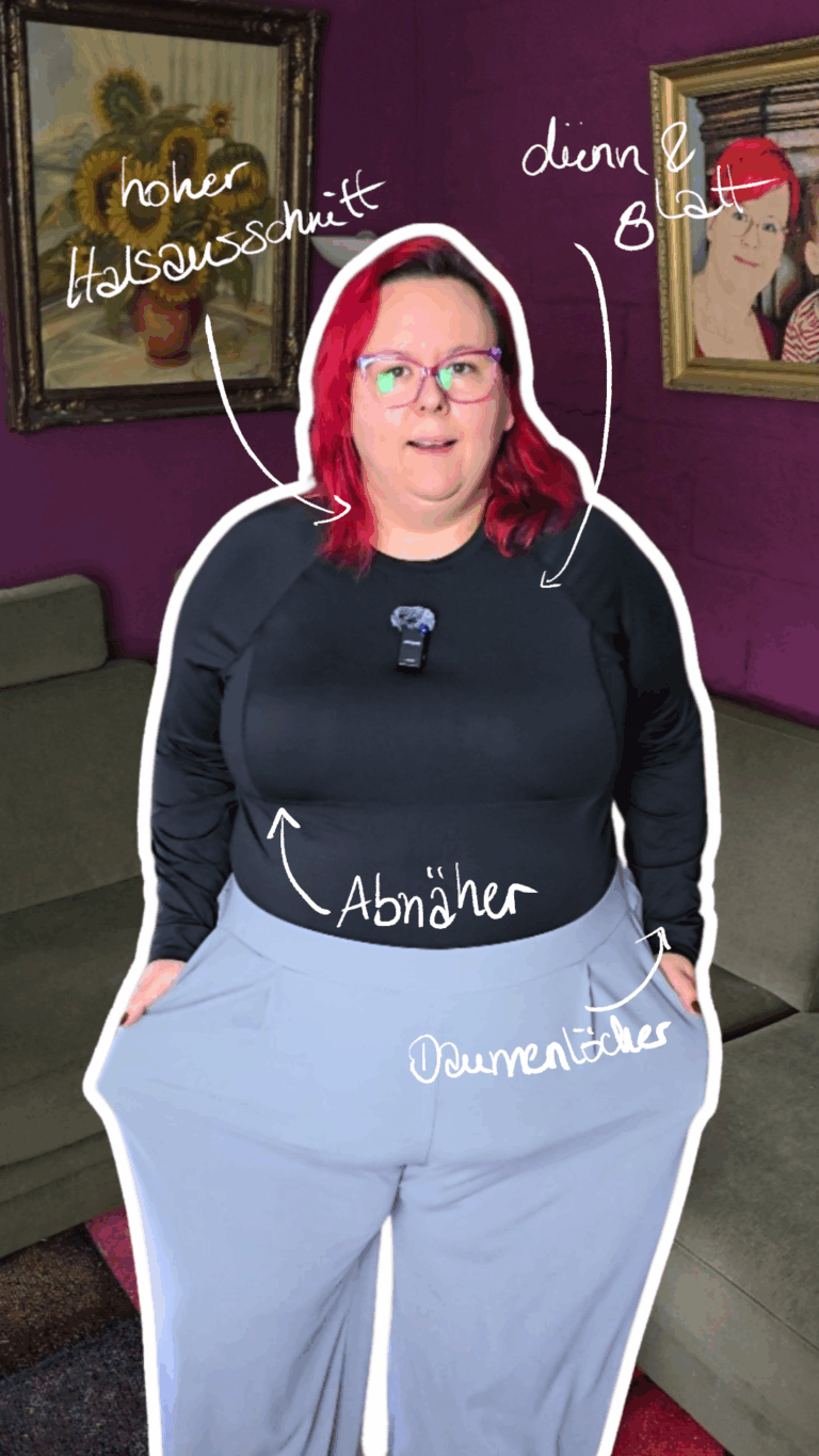 Dicke Frau mit roten Haaren trägt ein langärmliges Sportoberteil in schwarz.